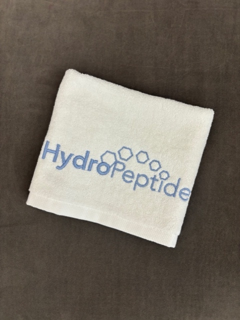 Darček Malý bavlnený uterák Hydropeptide biely s modrou výšivkou 35x35 cm<br>Towel Hydropeptide small white, blue sign 